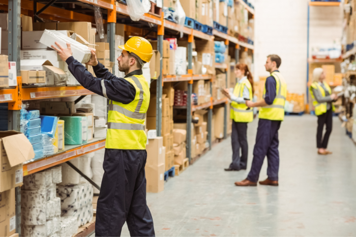 worker loading box onto pallet rack