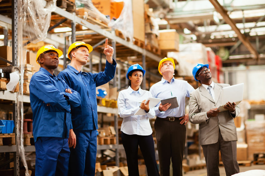 employees surveying a warehouse