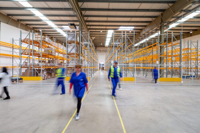 workers walking through organized warehouse