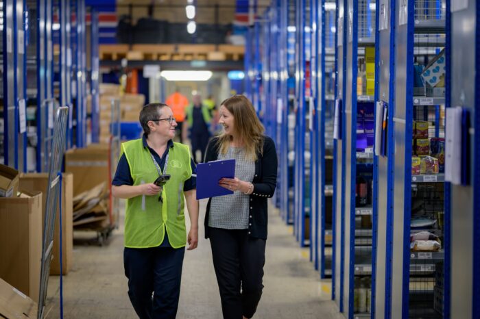 two people in warehouse with clipboard